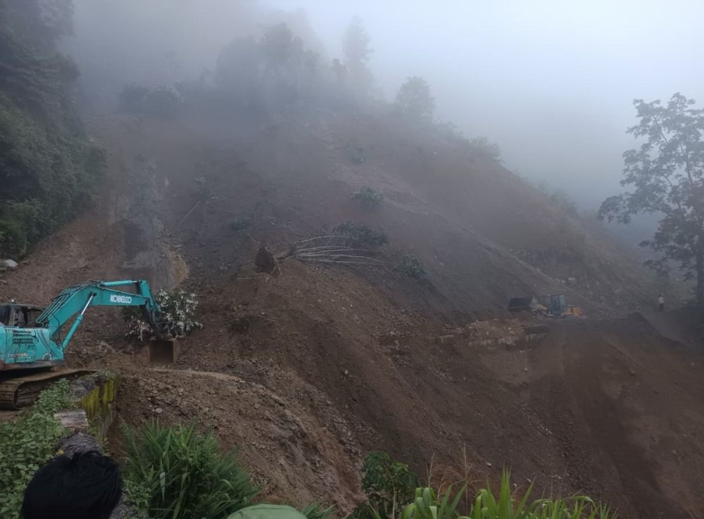 Earthmoving equipment clears debris after a massive rain-triggered landslide blocked NH-702A between Satakha and Kilomi Village on August 1. (Morung Photo)